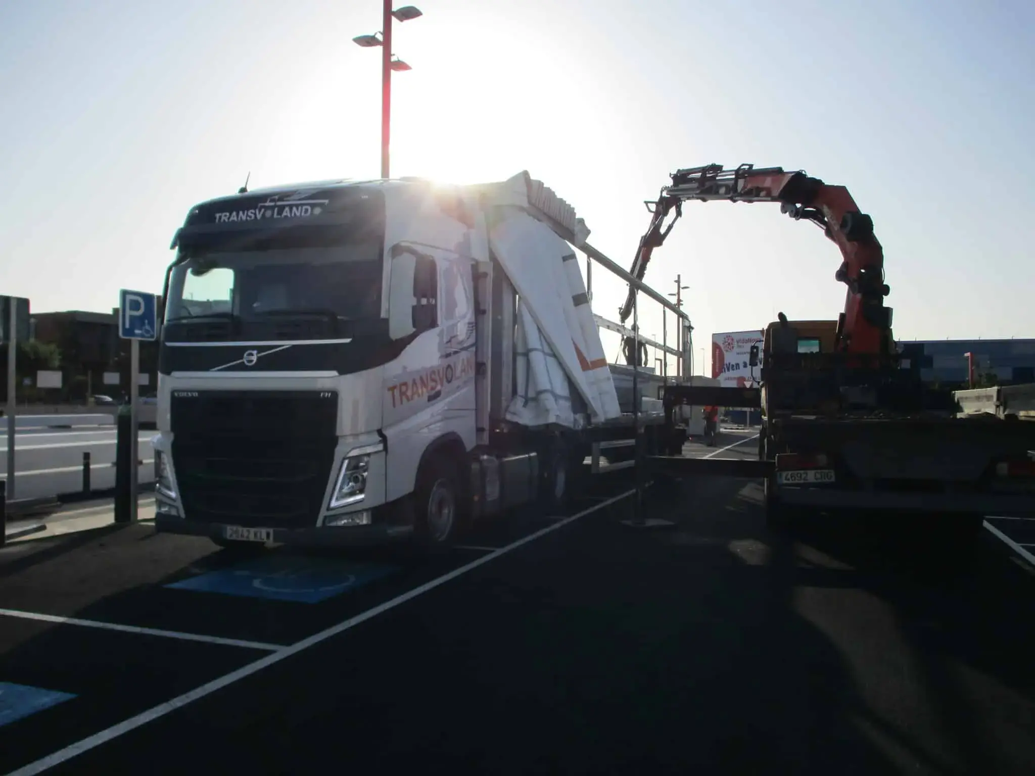 Efficient Unloading: Transvolando truck using a crane truck for unloading cargo.
