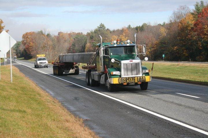 Abnormal loads Spain UK — escort vehicles and low-loader trailer for oversize cargo